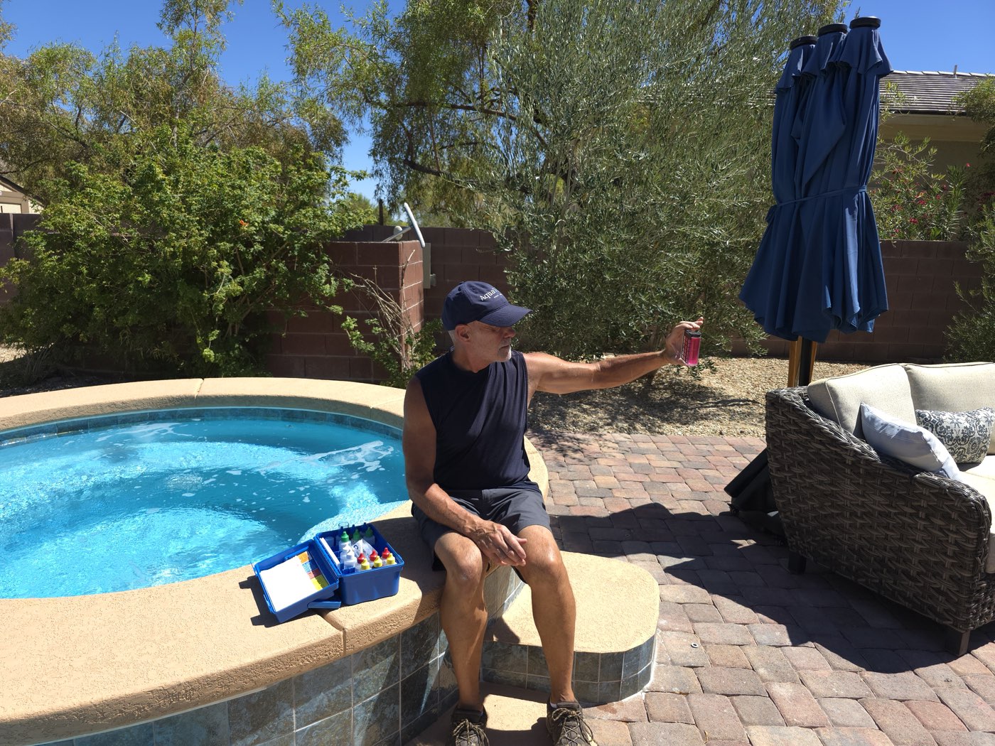 Michael running a full water chemistry test poolside with a drop test kit