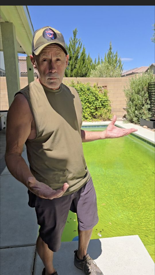 Michael Brown of AquaVision Pool Care standing beside a bright green algae-filled backyard pool in the Las Vegas Valley at the start of a 4-day recovery