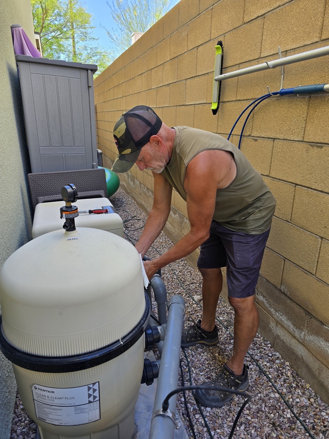 Michael Brown, AquaVision Pool Care Certified Pool Operator, servicing a cartridge filter housing at a Las Vegas residential pool