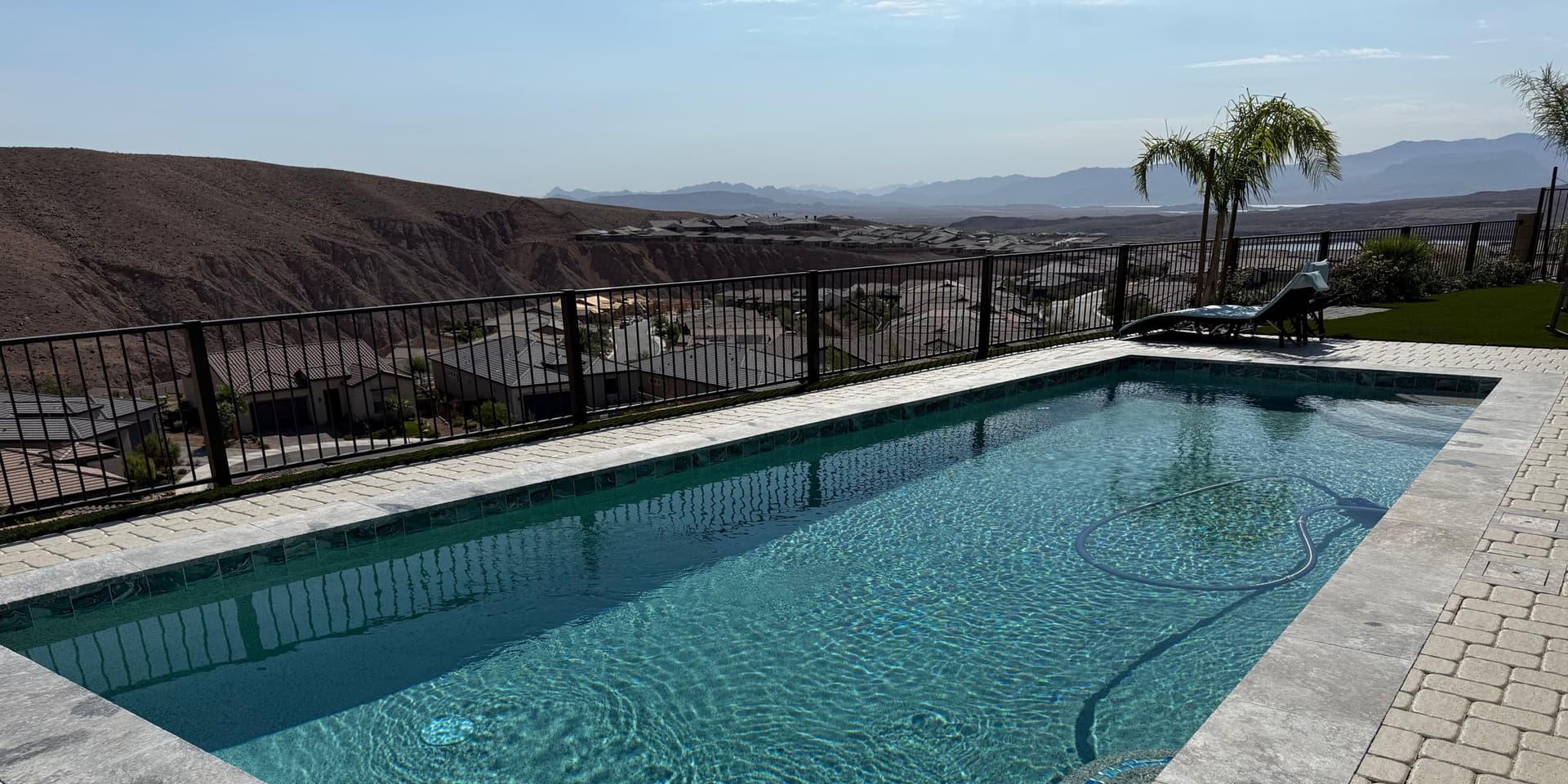 An elevated view-lot residential pool with Henderson mesa and valley views, cared for by AquaVision Pool Care