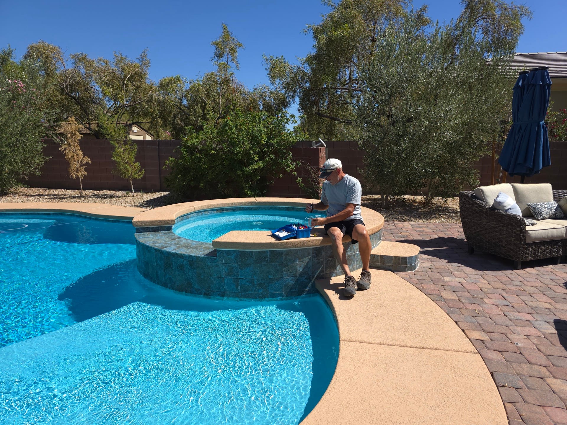 Michael Brown, AquaVision Pool Care owner, testing pool water chemistry at a Las Vegas residential pool