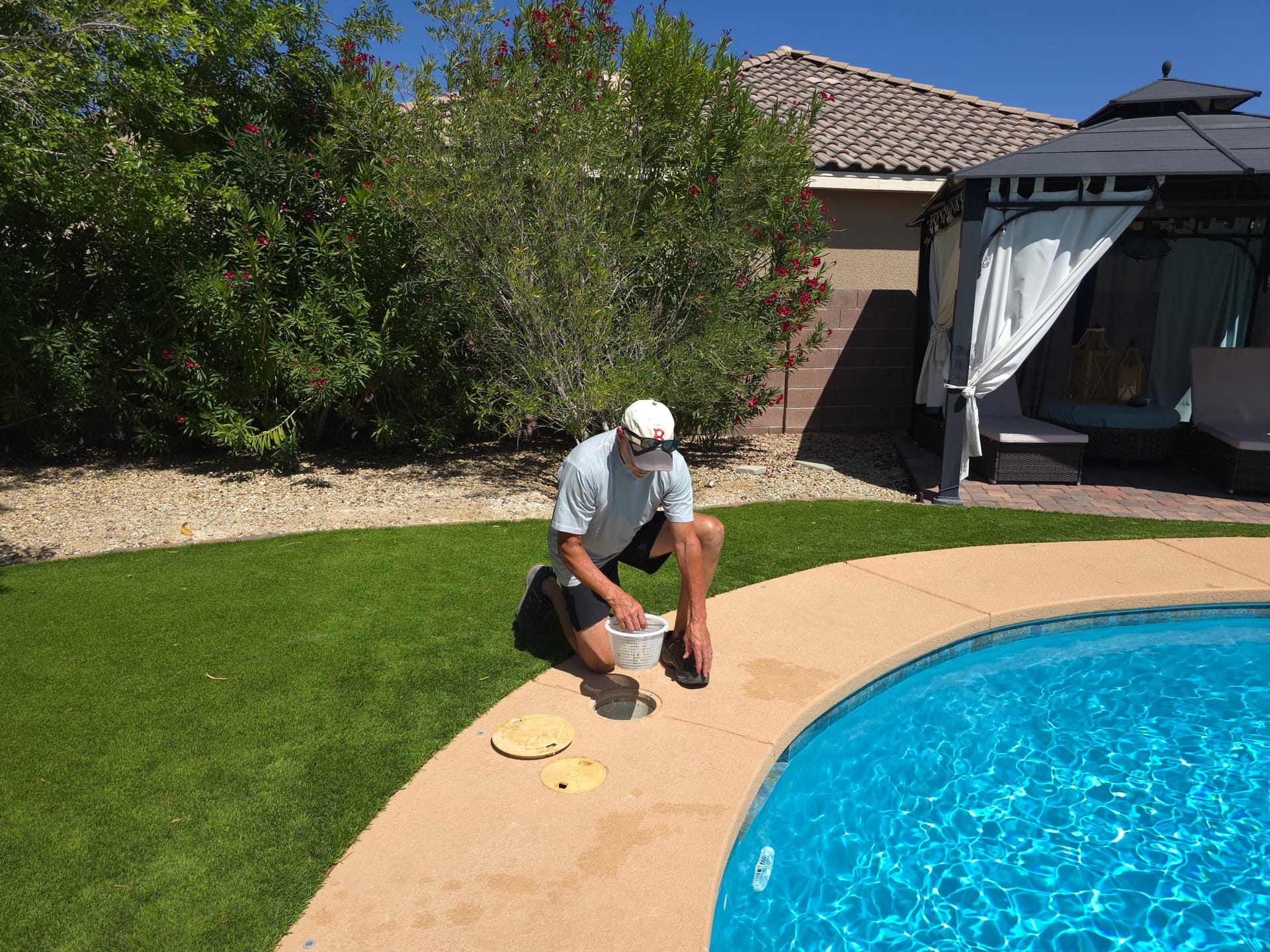 Michael Brown, AquaVision Pool Care Certified Pool Operator, inspecting pool equipment at a Las Vegas residential pool